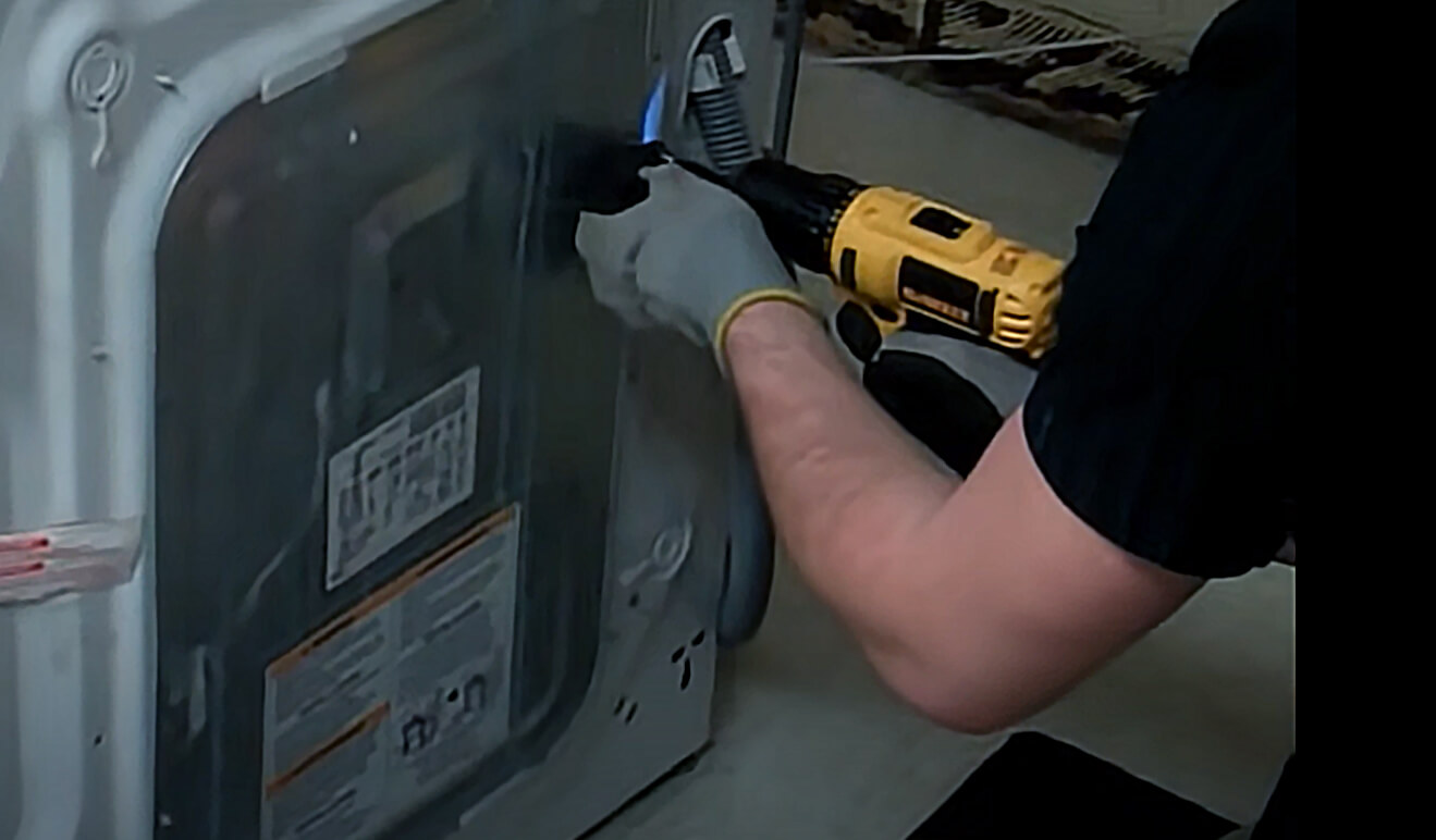 A technician repairing an appliance with the appropriate tools