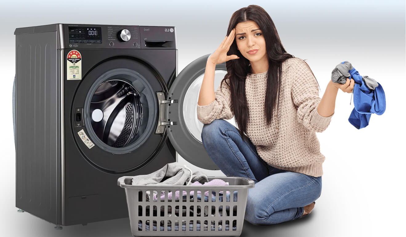 A Woman sitting next to a black washing machine, with a laundry basket kept before her