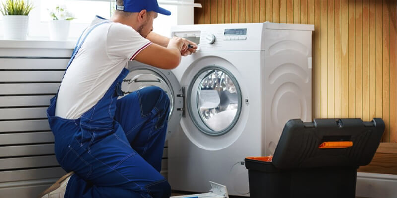 An expert technician fixing a washing machine